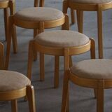 Modern Swedish, set of 14 stackable stools in birch and hessian fabric, 1980s.