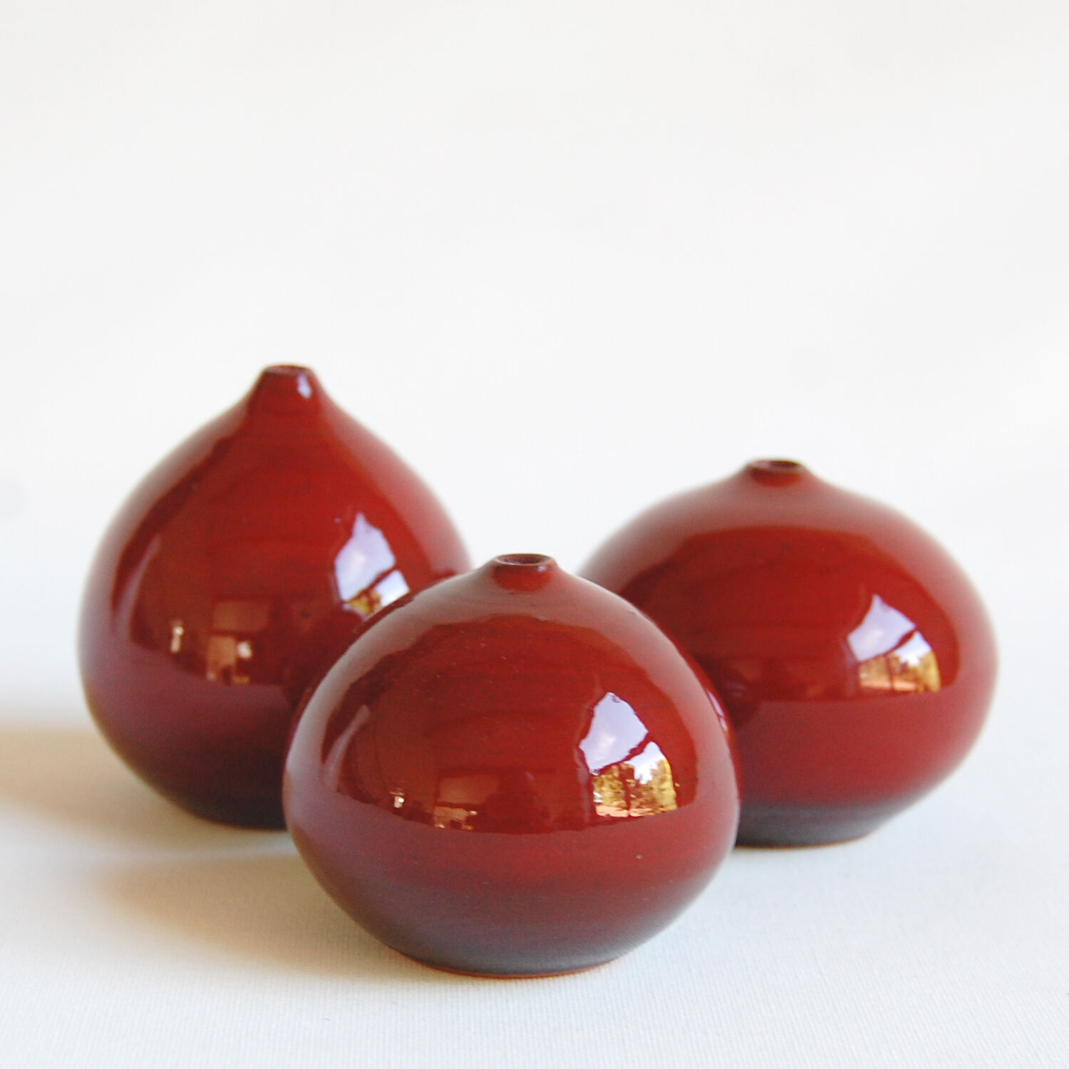 Trio of red miniature ceramics by Antonio Lampecco