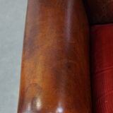 Sheep leather wingback chair with a red corduroy seat cushion and patina