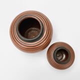 Pair of Elchinger ball vases with asymmetrical black stripes on an auburn background