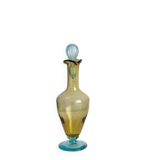 Old glass vial in yellow and blue.