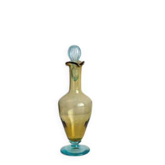 Old glass vial in yellow and blue.