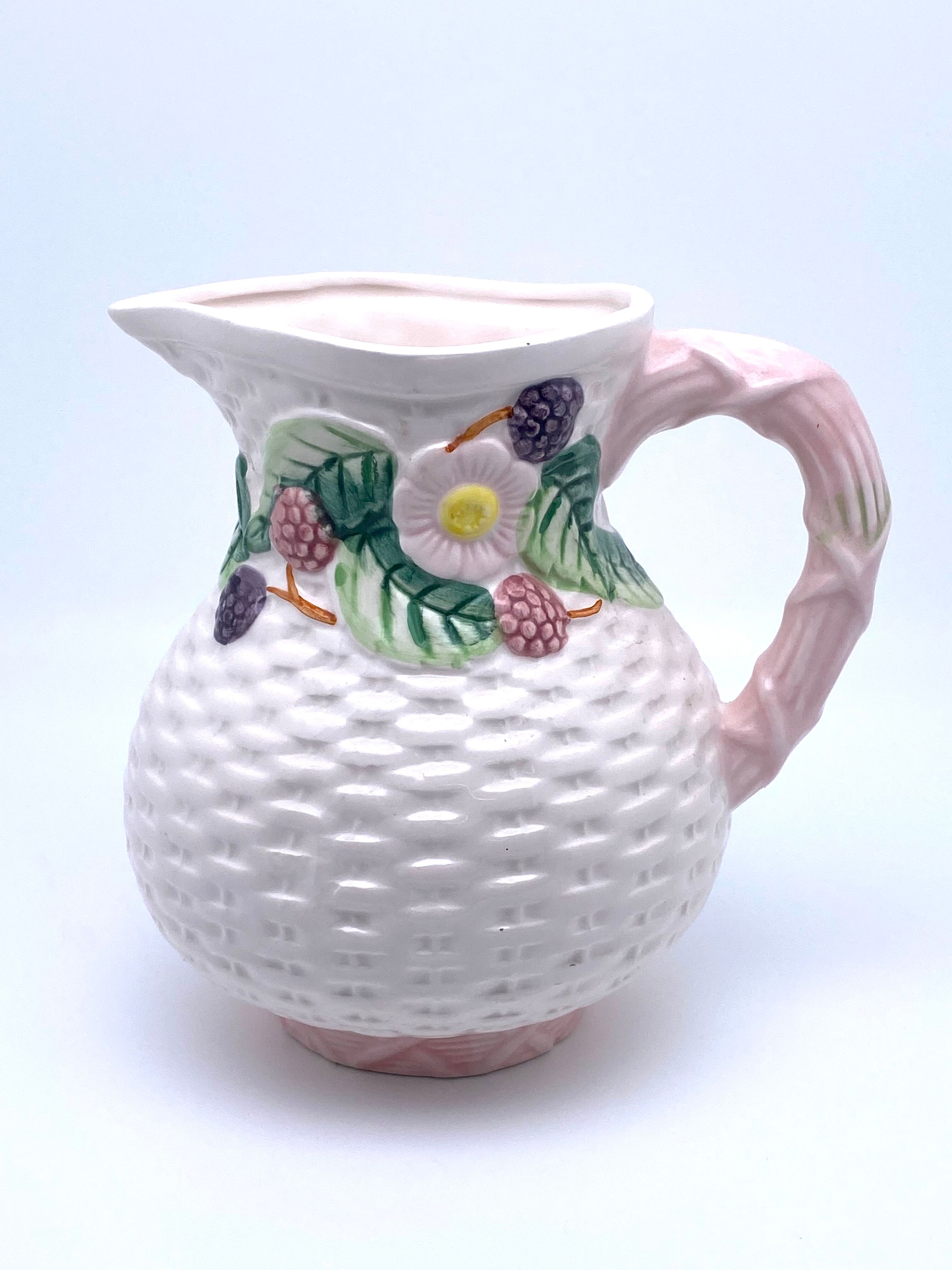 Pale pink slip decanter and colorful fruist