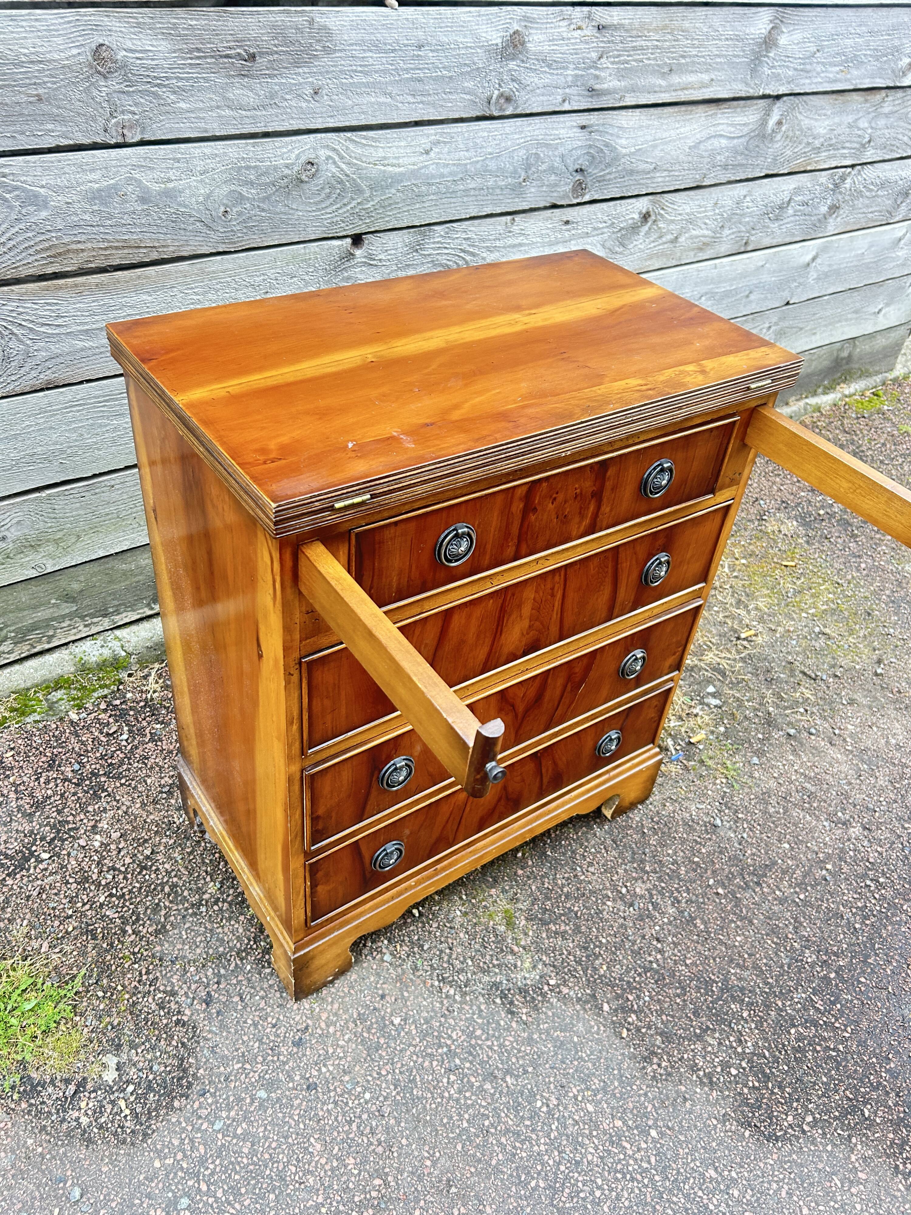 Small English chest of drawers with a folding top.