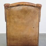 Characteristic antique sheepskin leather armchair with beautiful details and a unique design