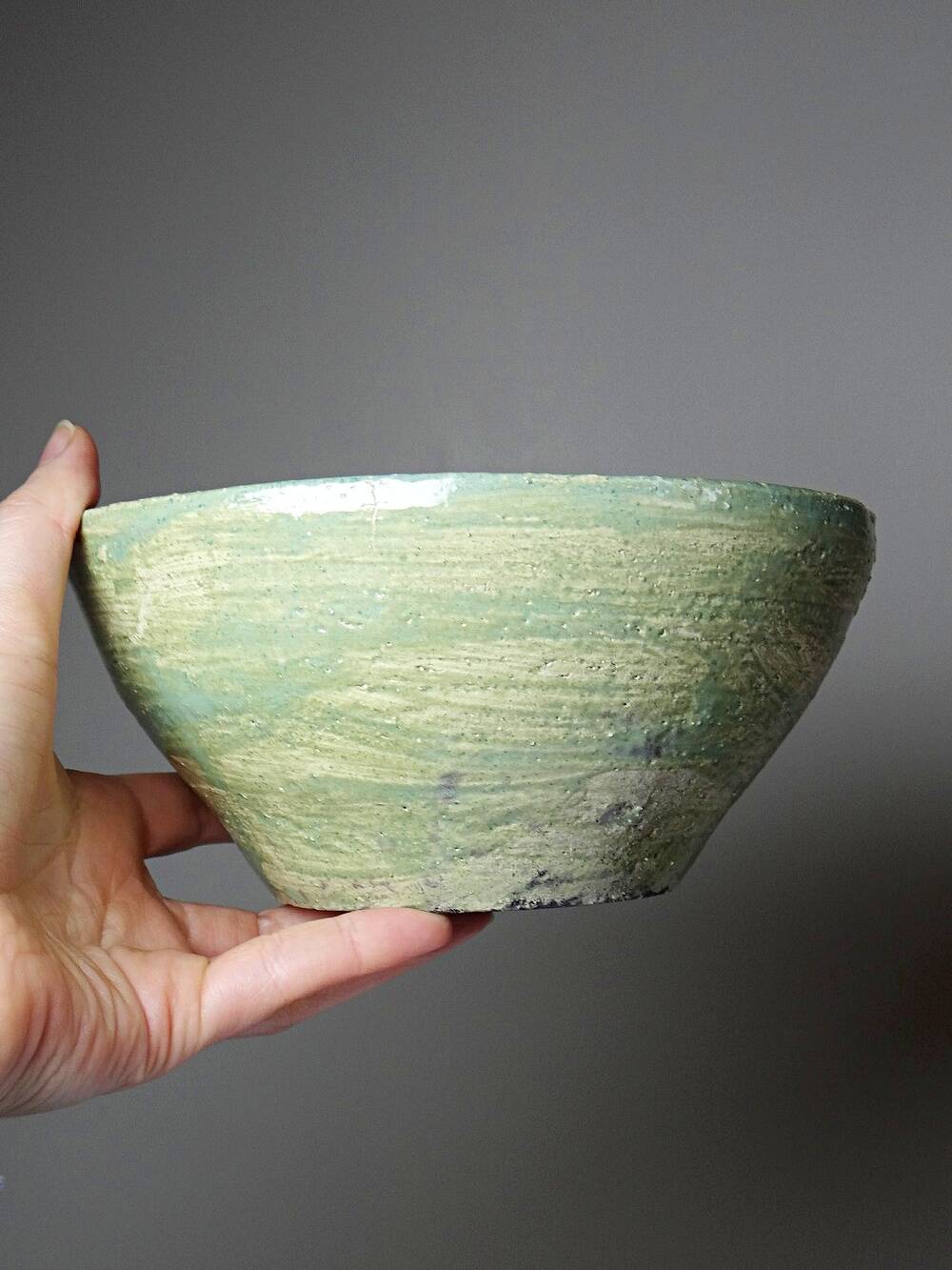 Wabi-Sabi handcrafted ceramic bowl in celadon green, 20th-19th century.