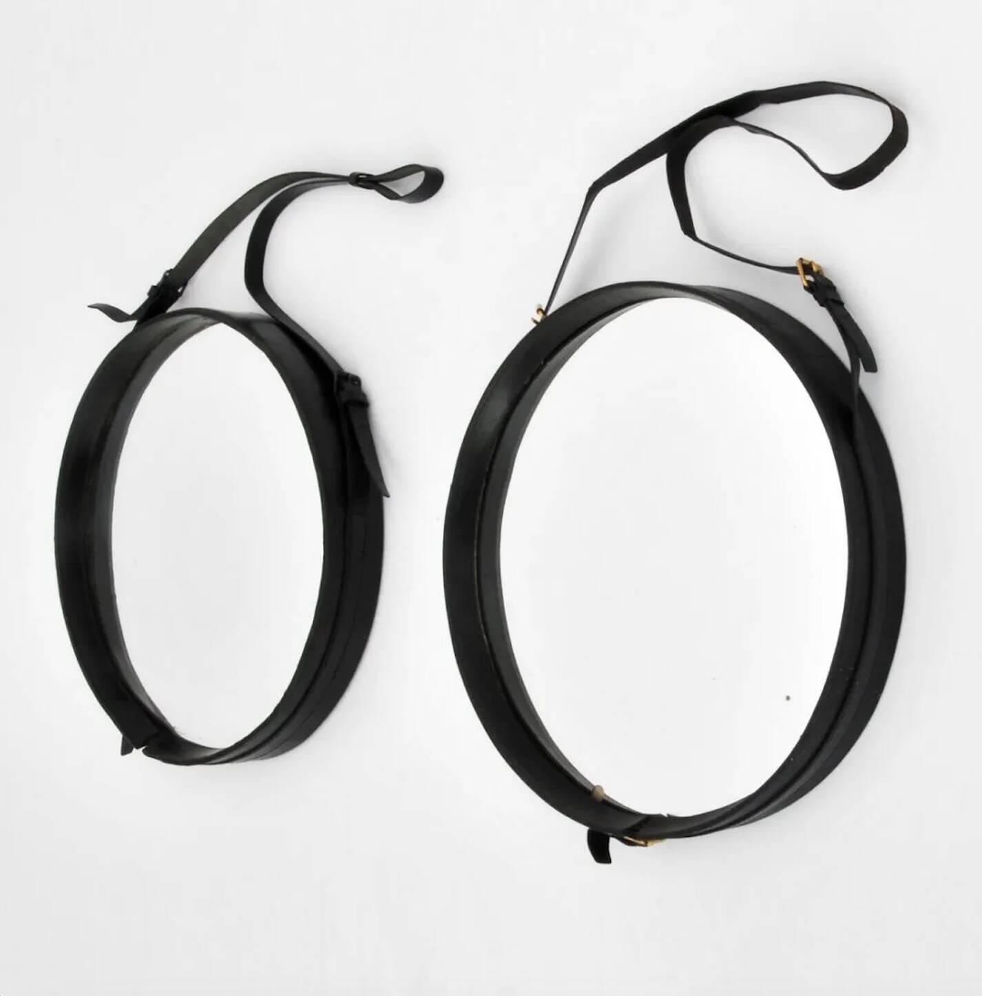 Jacques Adnet pair of circular leather and brass mirrors