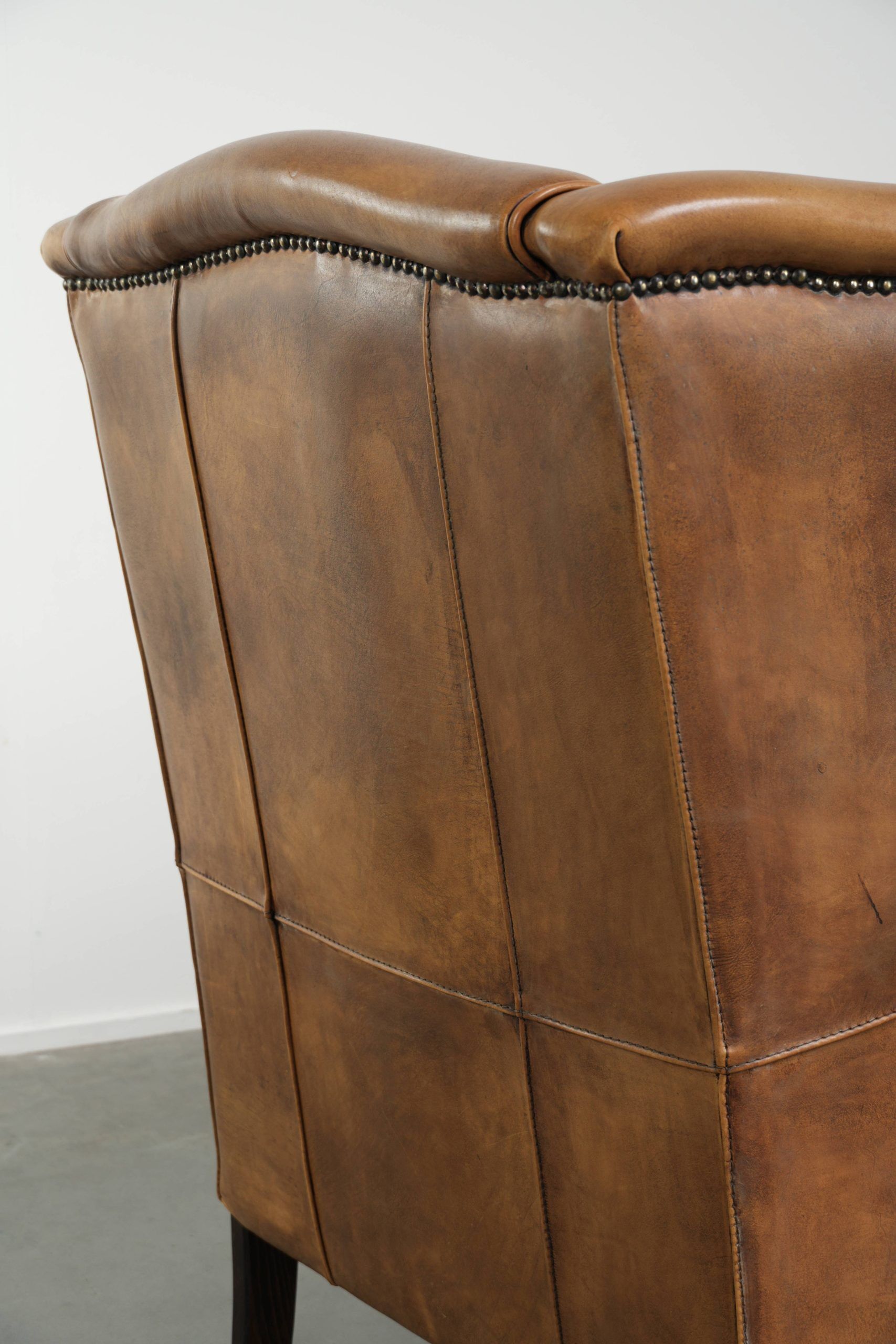 Comfortable cowhide wingback armchair with a timeless English look