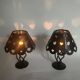 Pair of black wrought iron lanterns with heart patterns, romantic style.
