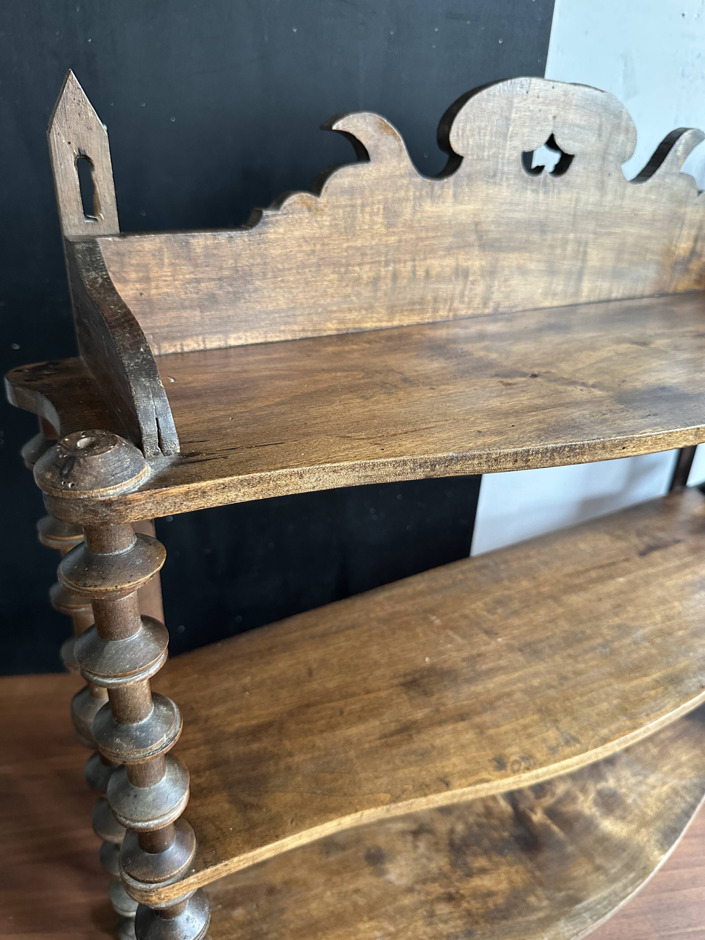 Antique wall shelf made of turned wood and spools of thread, late 19th century.
