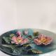 Decorative plate with relief floral pattern in majolica.
