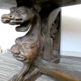 Gothic bench made of solid wood, heads of carved grotesques