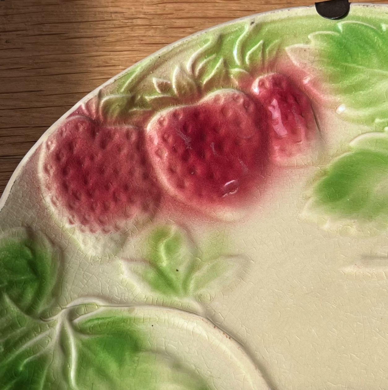 Plate in slip decoration strawberries and leaves