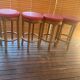 Set of 4 bar stools in solid exotic wood and red leather.