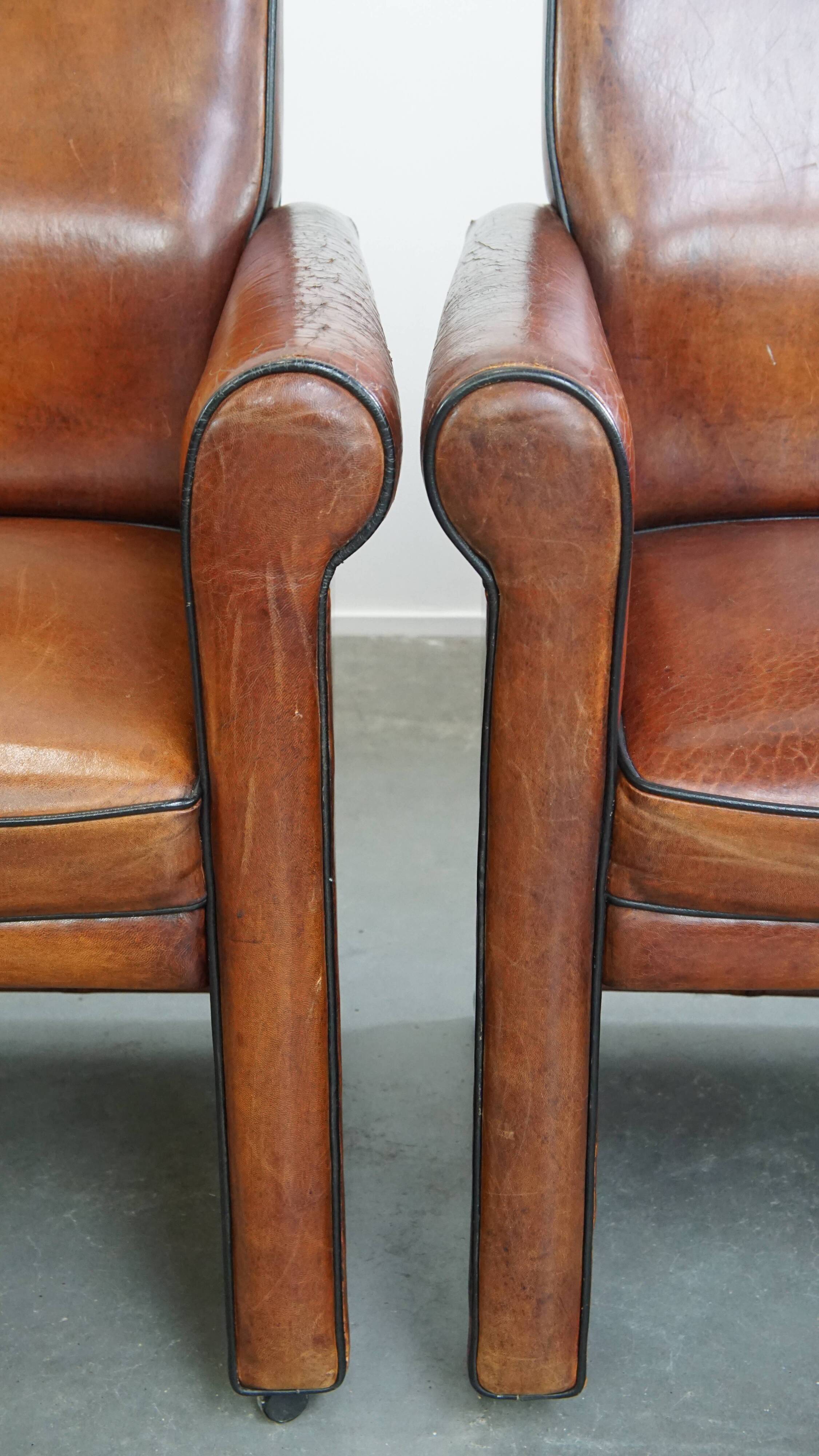 Vintage set of 4 sheepskin leather dining chairs on castors