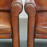 Vintage set of 4 sheepskin leather dining chairs on castors