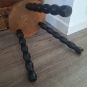 Brown and black wooden tripod stool