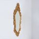 French Rococo or Baroque style facet-cut crest mirror in gilded carved wood