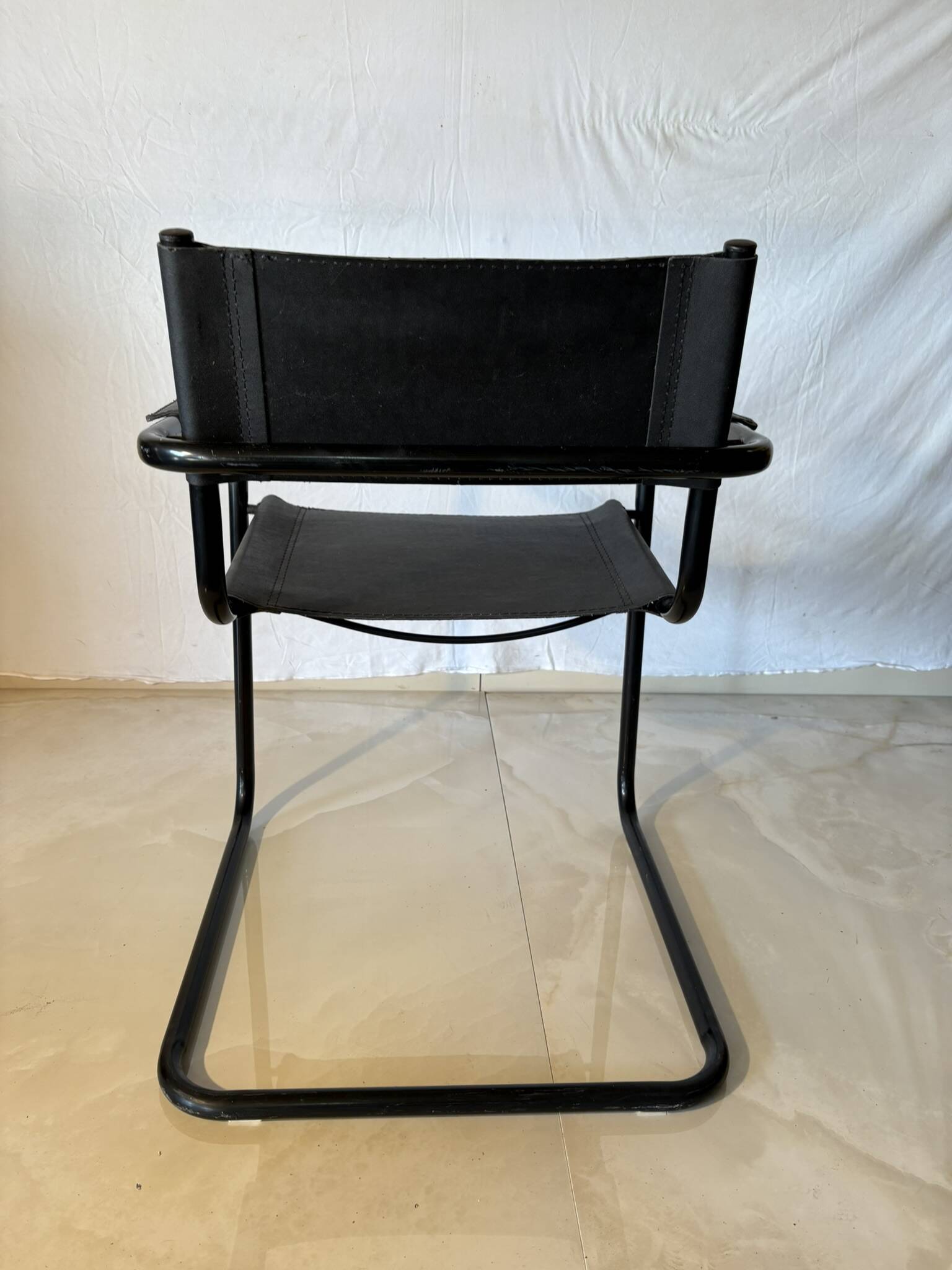 Set of 12 vintage chairs in black leather and tubular steel – Italy, 1970s