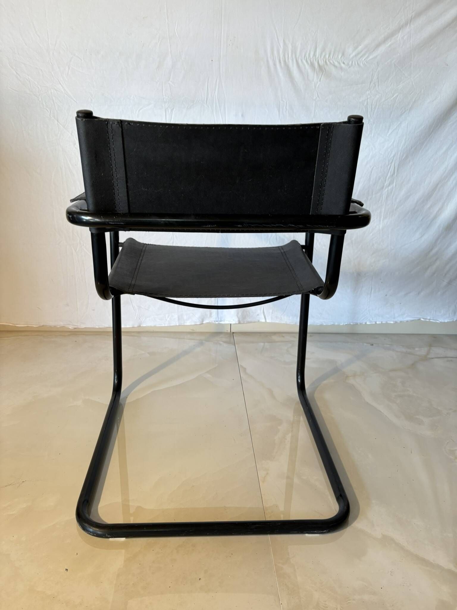 Set of 12 vintage black leather and tubular steel chairs – Italy, year