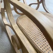 Rocking chair with a cane seat and backrest.