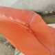 Orange leather cantilever tubular armchair