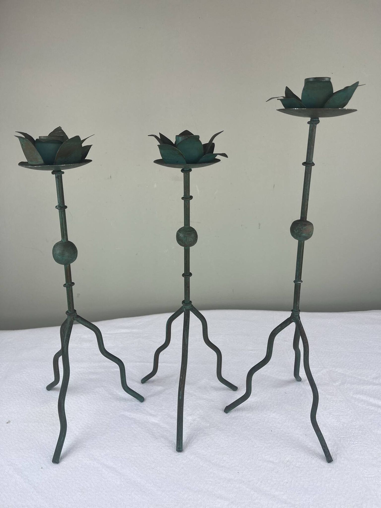 Sculptural candle holder trio