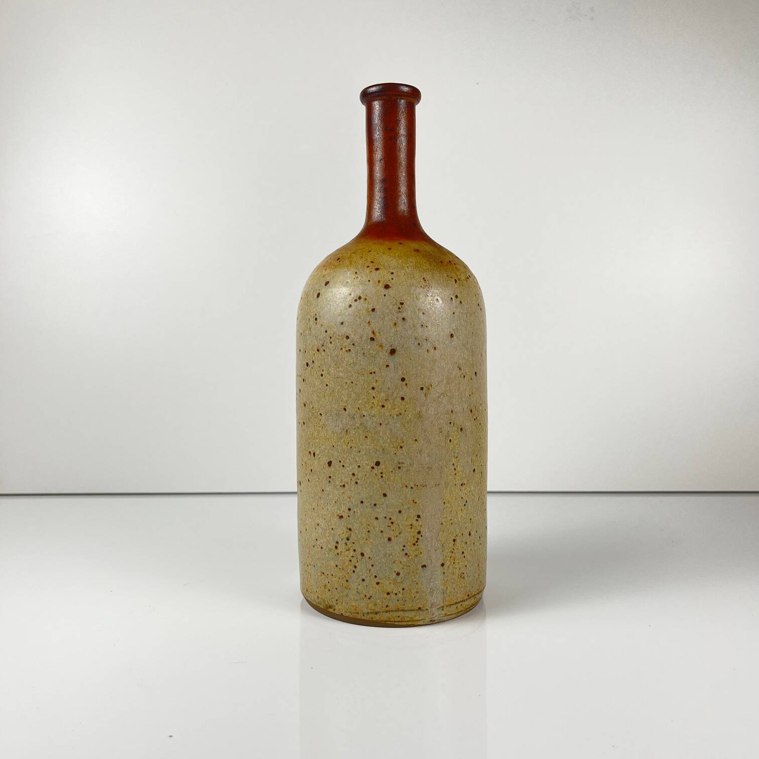 Duo of speckled stoneware and burgundy bottles, 20th century