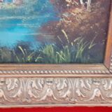 Old oil with golden frame. The lake.