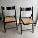 Vintage folding chairs in black wood and cane.