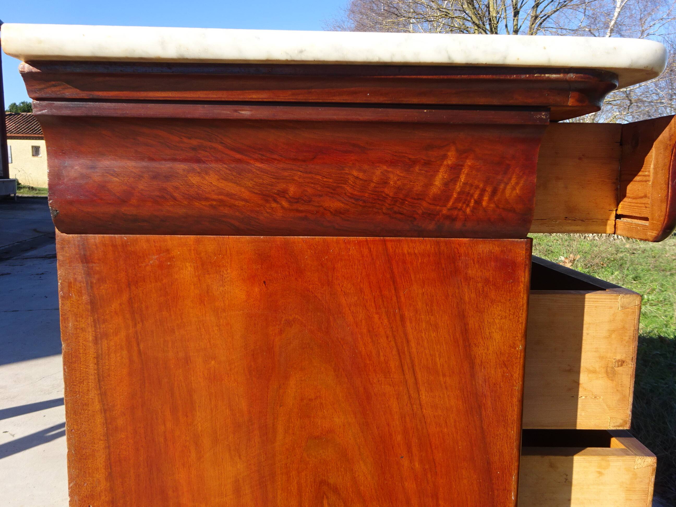 Antique mahogany chest of drawers with white marble.