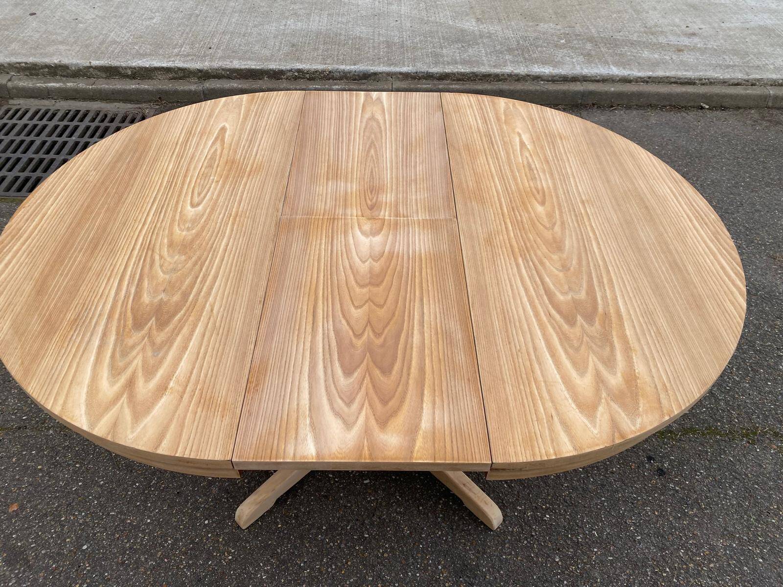 Scandinavian Baumann round extendable dining table with central leg, 115cm.