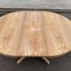 Scandinavian Baumann round extendable dining table with central leg, 115cm.