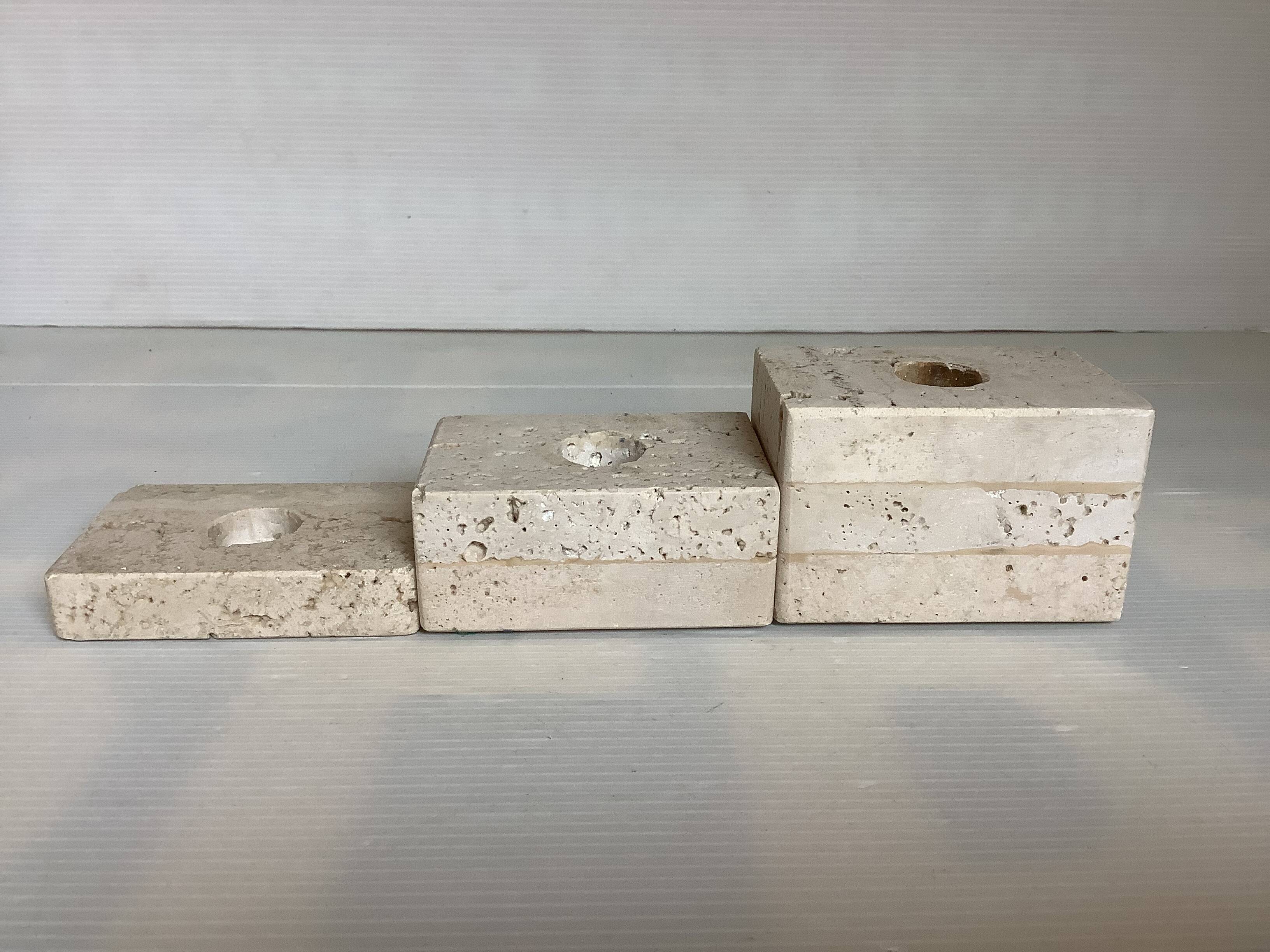 Trio of travertine candlesticks