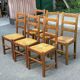 6 light solid wood chairs with high straw backs, farmhouse style.