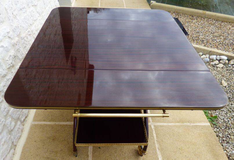 Chic serving table on wheels from the 60s with brass decorations and two shelves.