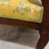 Louis XV style cabriolet armchair in solid wood, yellow floral fabric.
