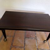 Lacquered coffee table with vintage wheels 70s