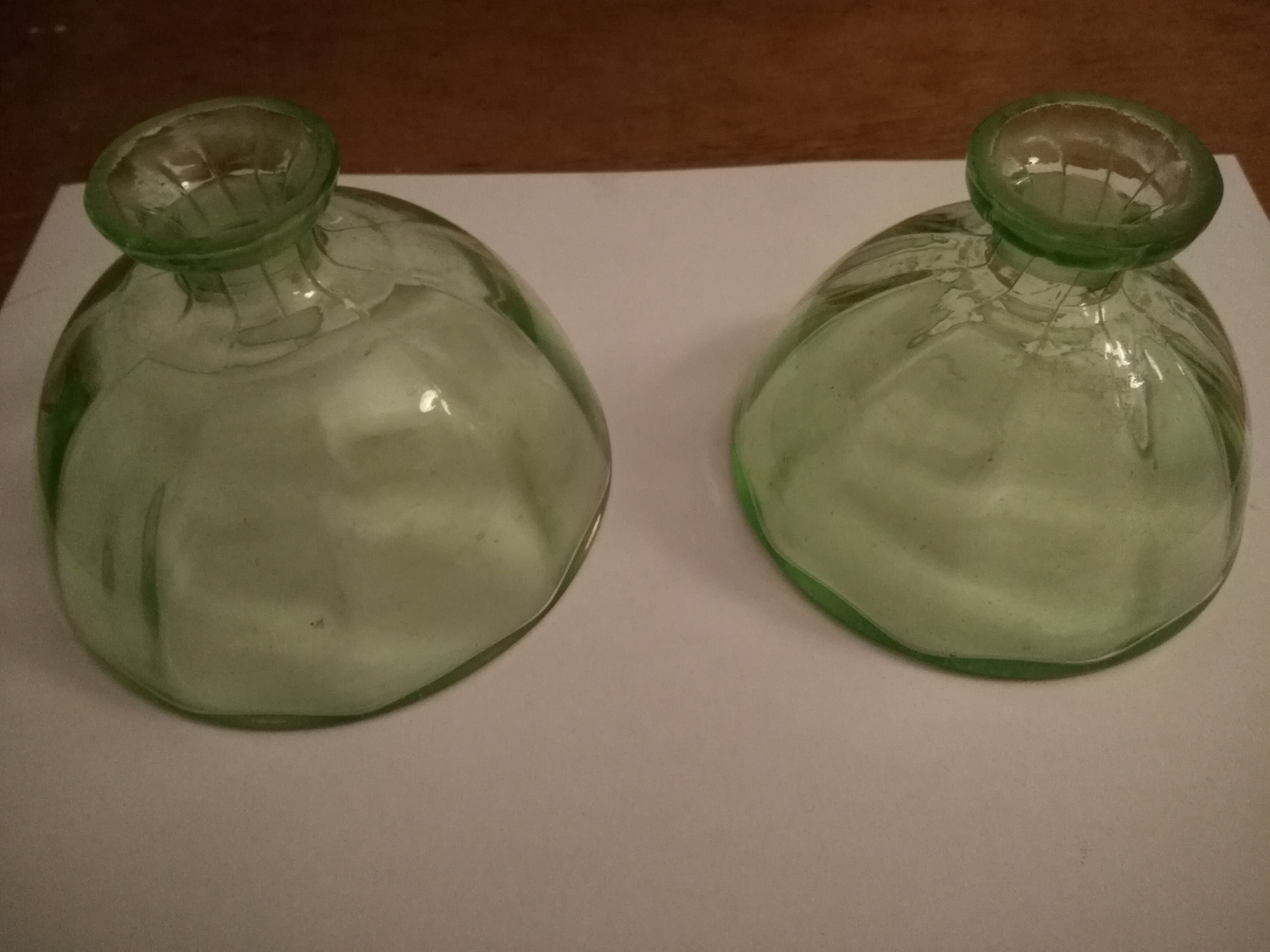 Two bottles in glass, (certainly), surroundings of the 1930s
