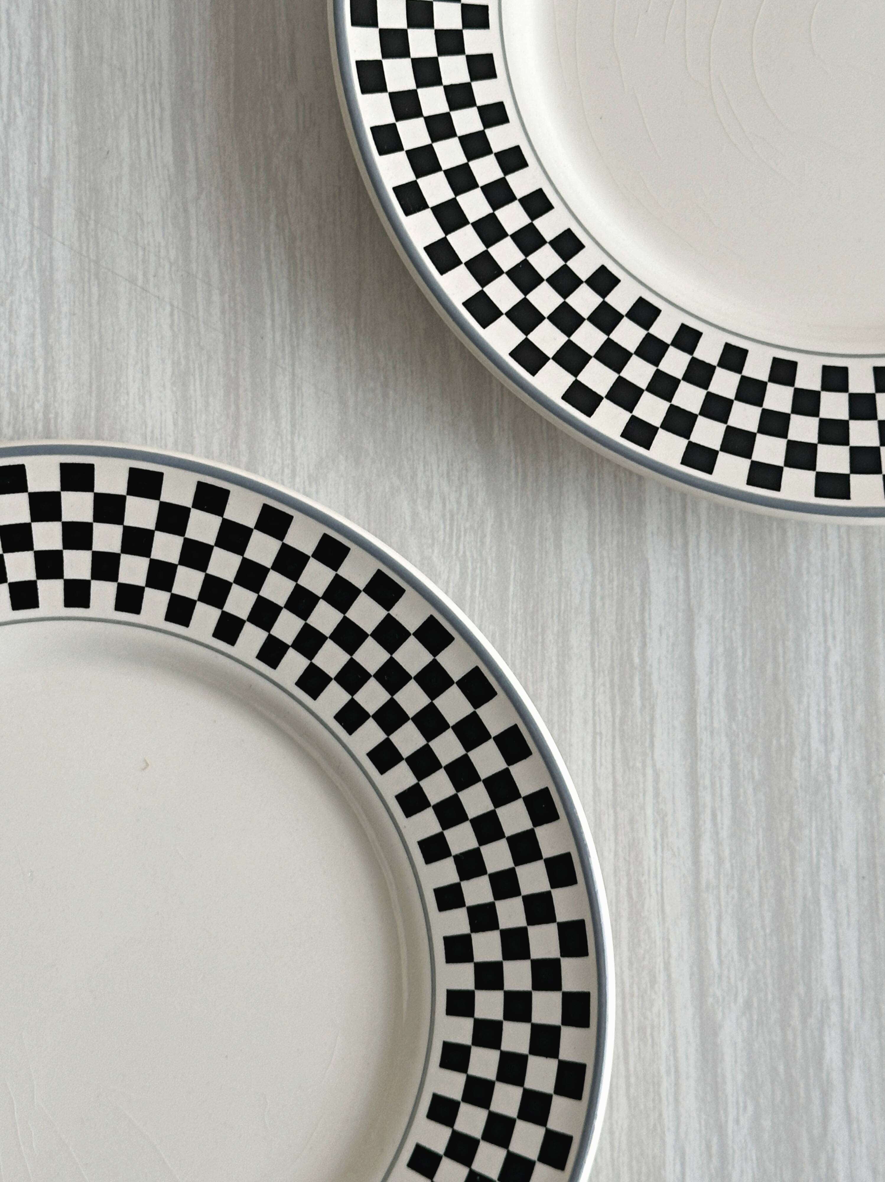 Pair of vintage plates with a black and white checkered pattern.