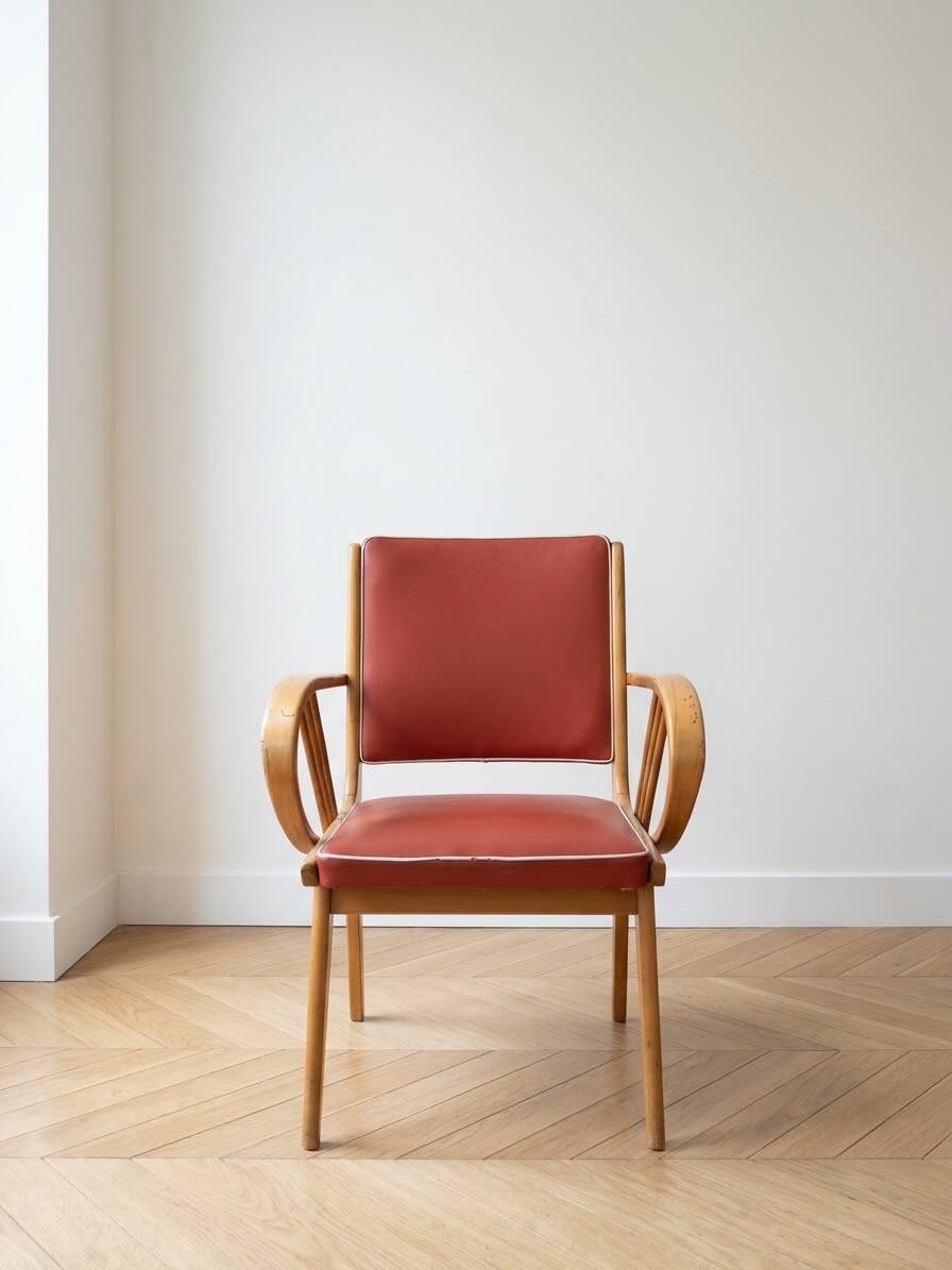 Vintage 1950s armchair in wood and red faux leather.