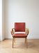 Vintage 1950s armchair in wood and red faux leather.