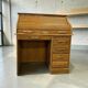 Vintage American wooden desk with a roll-top.