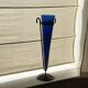Cobalt blue vase on a metal structure.