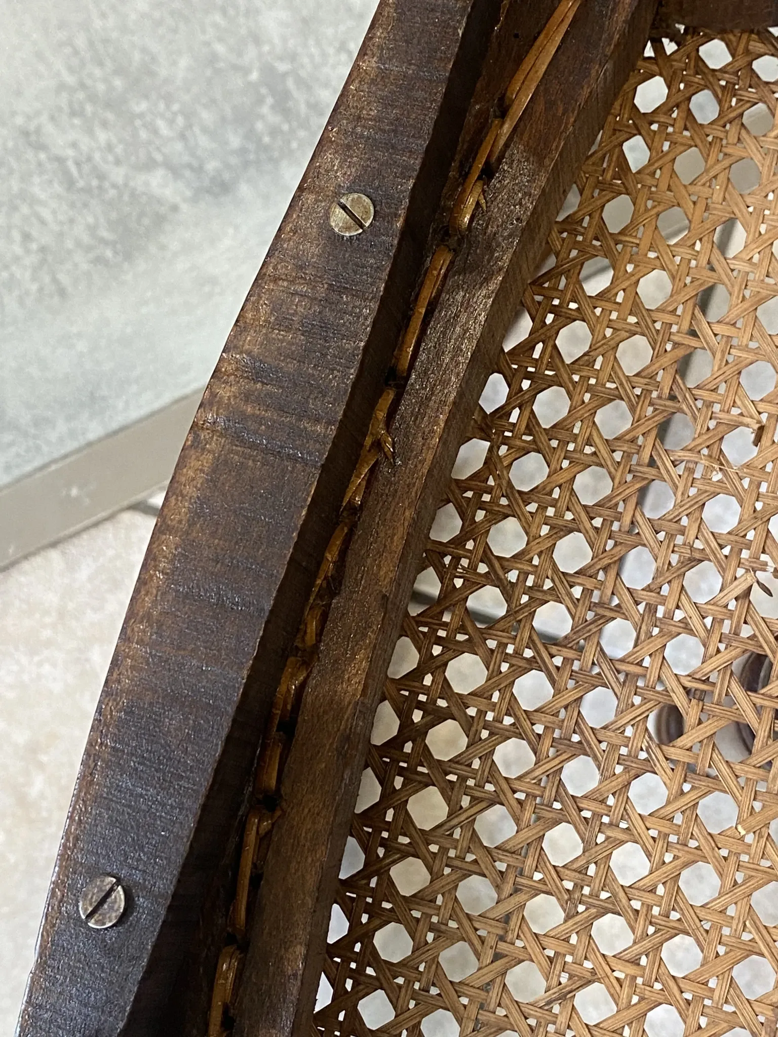 Pair of antique caned and wooden chairs from the 1900s.