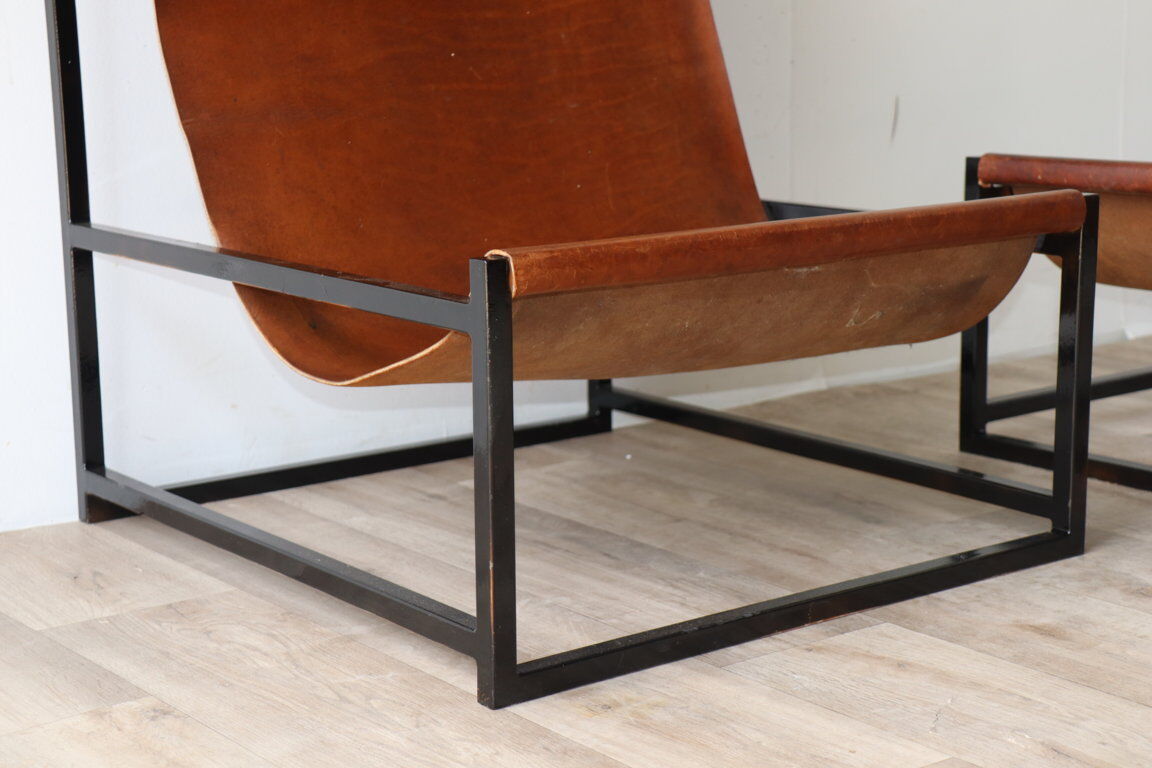 Pair of vintage armchairs in stretched leather and metal structure