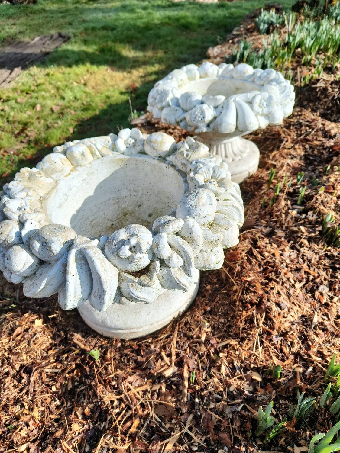 Pair of round stone fruit bowls on foot