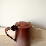 Old pitcher in brown enamelled sheet metal, spout and lid