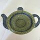 Rattan basket in the shape of a teapot.