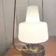 Table lamp in gold metal and opaline.